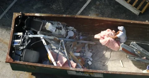 Construction workers throwing waste into dumpster Ariel top view Video stock 213385317