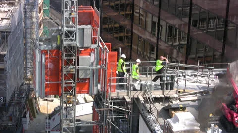Construction workers on top of tall building Stock Footage 26059973