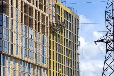 Construction Workers Use a Lift to Work on the Upper Floors of a Building i.. Stock Photos