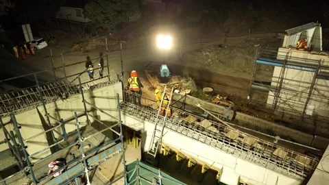 Construction workers using an angle grinder to cut steel rebar during a bridge Stock Footage 342218291