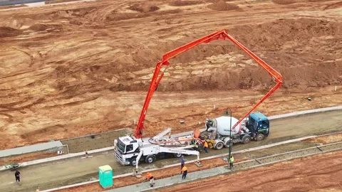 Construction workers using concrete pumper for new footpath Stock Footage 278300934