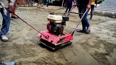 Construction Workers Using Ground Vibrator Stock Footage 320958630