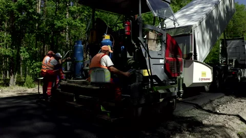 Construction Workers Using Heavy Machinery During Road Construction Stock Footage 142005660