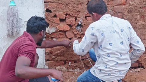 Construction workers using measurement tape to aligning string line for Stock Footage 313058245