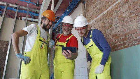 Construction workers using smartphone during break at work Stock Footage 133640235