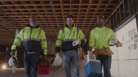 Construction Workers Walk Together Carrying Equipment Stock Footage 270389549