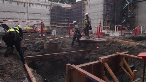 Construction workers walking around site Stock Footage 136806958