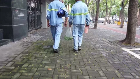 Construction workers walking home after long day, with vegetables and tea, China Stock Footage 160304824