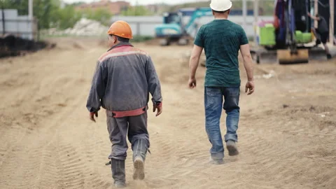 Construction Workers Walking on a Job Site Undergoing Various Tasks and Stock Footage 312634145