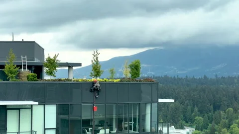 Construction workers wash windows one of the residential buildings in Vancouver Stock Footage 197216044