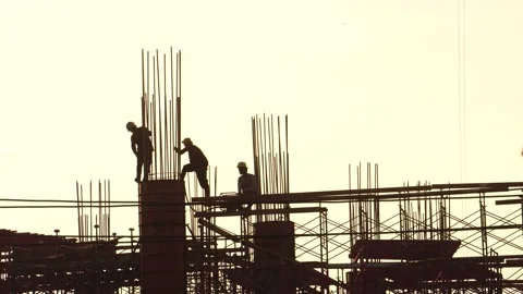 Construction workers watch a crane moving concrete container Stock Footage 142590813