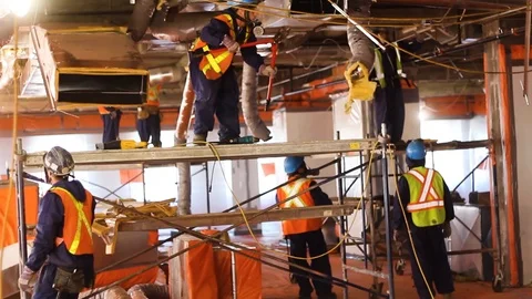 Construction workers, wearing construction hat and vest Stock Footage 87346537