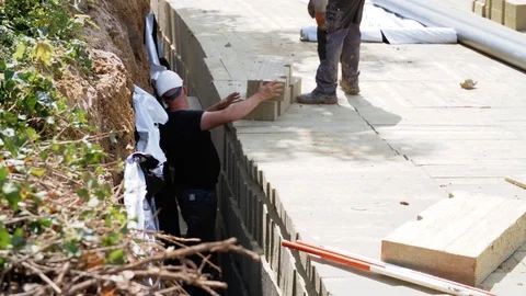 Construction Workers Wearing Helmets Working With Wooden Block Stock Footage 129398837