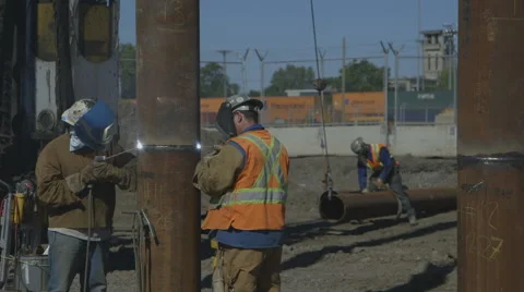 Construction workers welding foundation pile Stock Footage 65051675