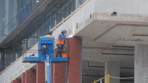 Construction Workers Welding Highrise Hoist Lift Condo Development Pro Stock Footage 87430602