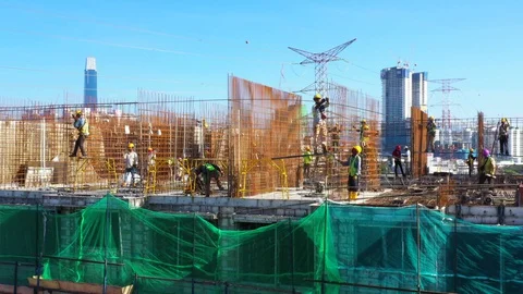Construction workers work on high rise buildings at the construction site Stock Footage 128125467