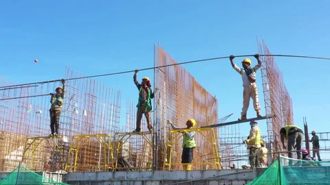 Construction workers work on high rise buildings at the construction site Stock Footage 128125482