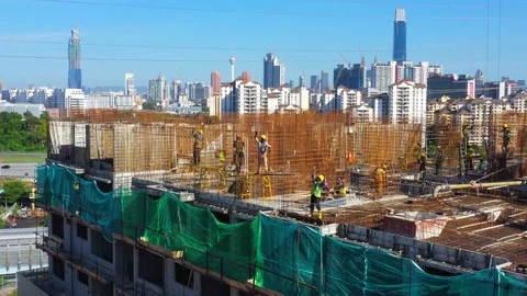 Construction workers work on high rise buildings at the construction site Stock Footage 128125490