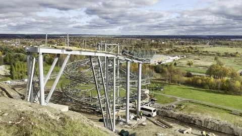 Construction workers work on the metalwork of the toboggan track in Ventspils Stock Footage 219552052