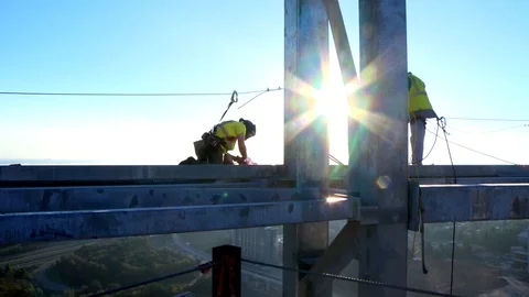 Construction Workers Work on Sky Scraper at Sunrise Stock Footage 127530808
