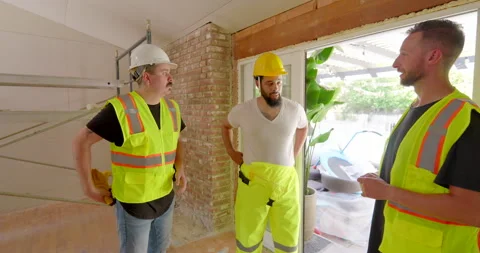 Construction Workers Work Together and Collaborate on a Home Remodeling Project Stock Footage 287128969