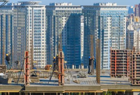 Construction workers work top building Stock Photos