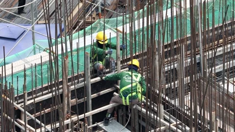 A construction workers  working on a building framework. Stock Footage 318406297