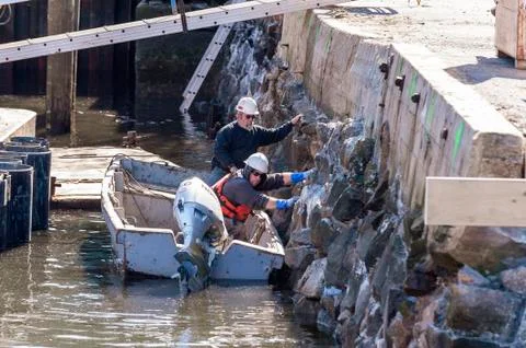 Construction workers working on Coalpocket Pier in New Bedford Stock Photos