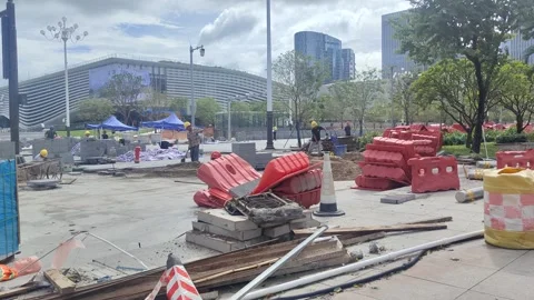 Construction Workers Working at a Concrete Site, Modern Buildings in the City Stock Footage 317840692