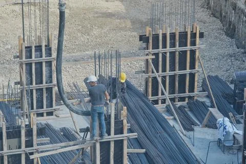 Construction workers working at the construction site Stock Photos