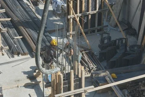 Construction workers working at the construction site Stock Photos