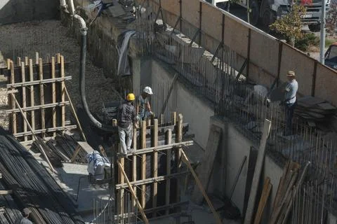 Construction workers working at the construction site Stock Photos