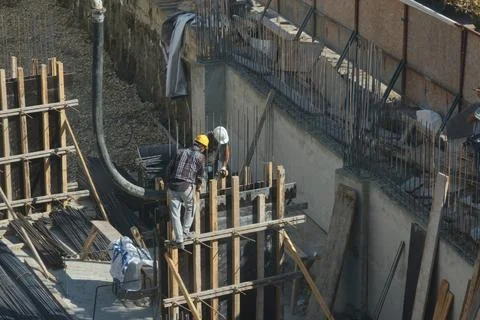 Construction workers working at the construction site Stock Photos