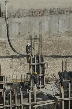 Construction workers working at the construction site Stock Photos