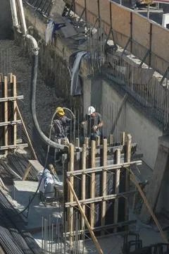 Construction workers working at the construction site Stock Photos