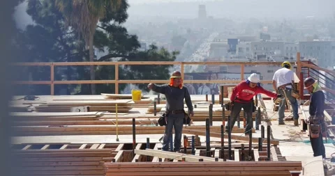 Construction workers working on high storeys apartment building site in LA, CA Stock Footage 306418926