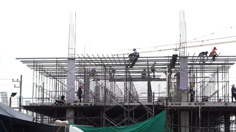 Construction workers working on new building with crane in background Stock Footage 61930520