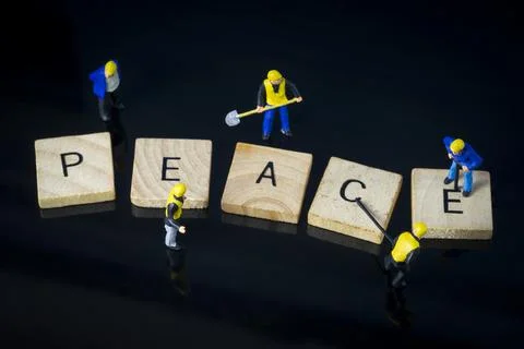 Construction workers working on peace letters miniature people macro Stock Photos