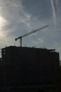 Construction workers working on roof of new building being built Stock Photos