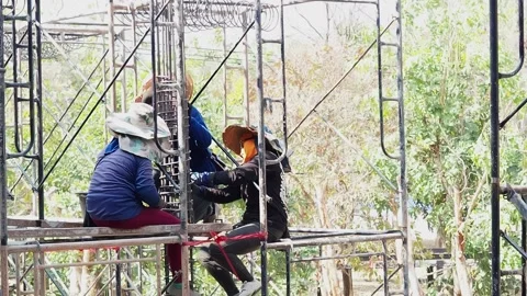 Construction workers working on scaffolding in a building site. Stock Footage 151887066