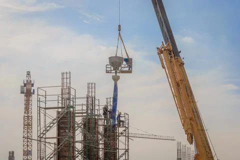 Construction workers working on scaffolding at a high level by the standard.. Stock Photos
