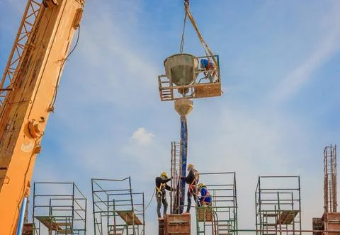 Construction workers working on scaffolding at a high level by the standard.. Stock Photos