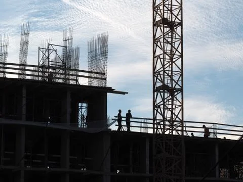 Construction workers working on scaffolding Stock Photos