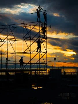 Construction workers working on scaffolding. Stock Photos
