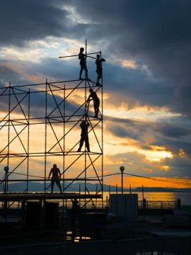 Construction workers working on scaffolding. Stock Photos