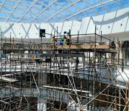 Construction workers working on scaffolding. Photos