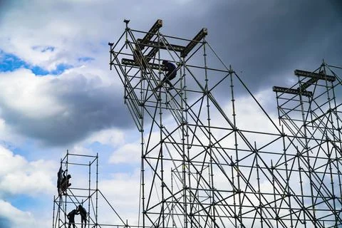 Construction workers working on scaffolding Stock Photos