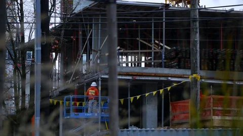 Construction Workers Working Seen Through Blades of Grass 動画素材 83147862