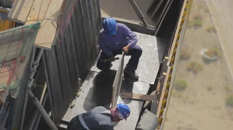 Construction Workers Working on Top of The Building Stock Footage 67273732