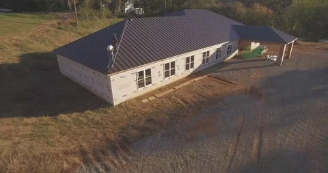 Construction workers working on top of a roof (drone) Stock Footage 107322053